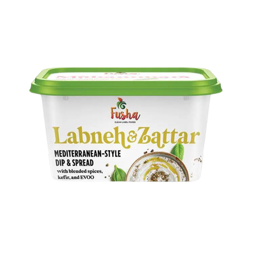 A container of labneh and spread on a green background.