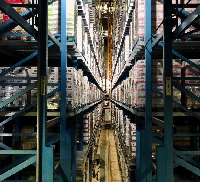 A warehouse with many rows of shelves and racks.
