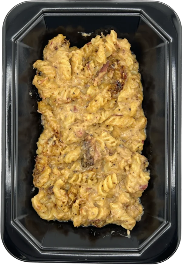 A container of macaroni and cheese with meat in it.